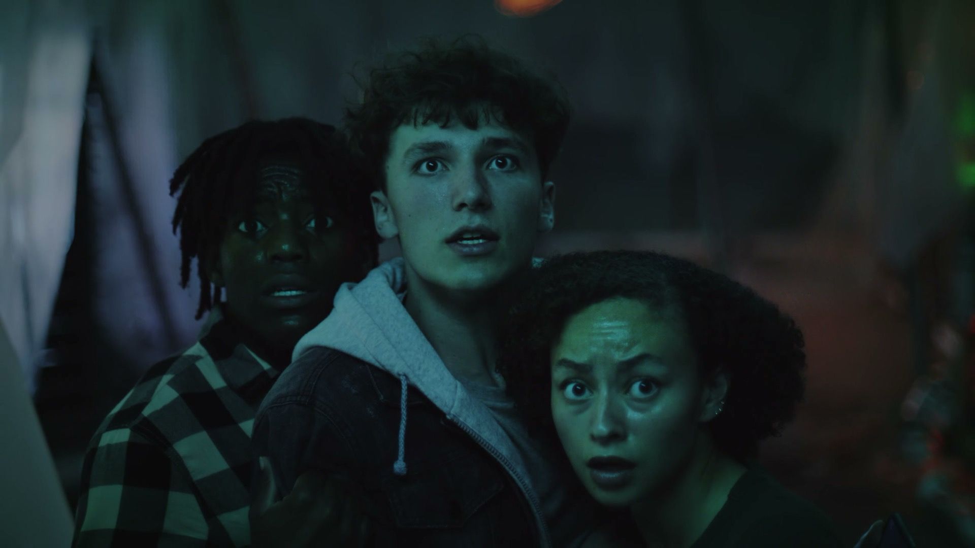 Three frightened teenagers stare into the dark, from the FDA youth vaping prevention trailer.
