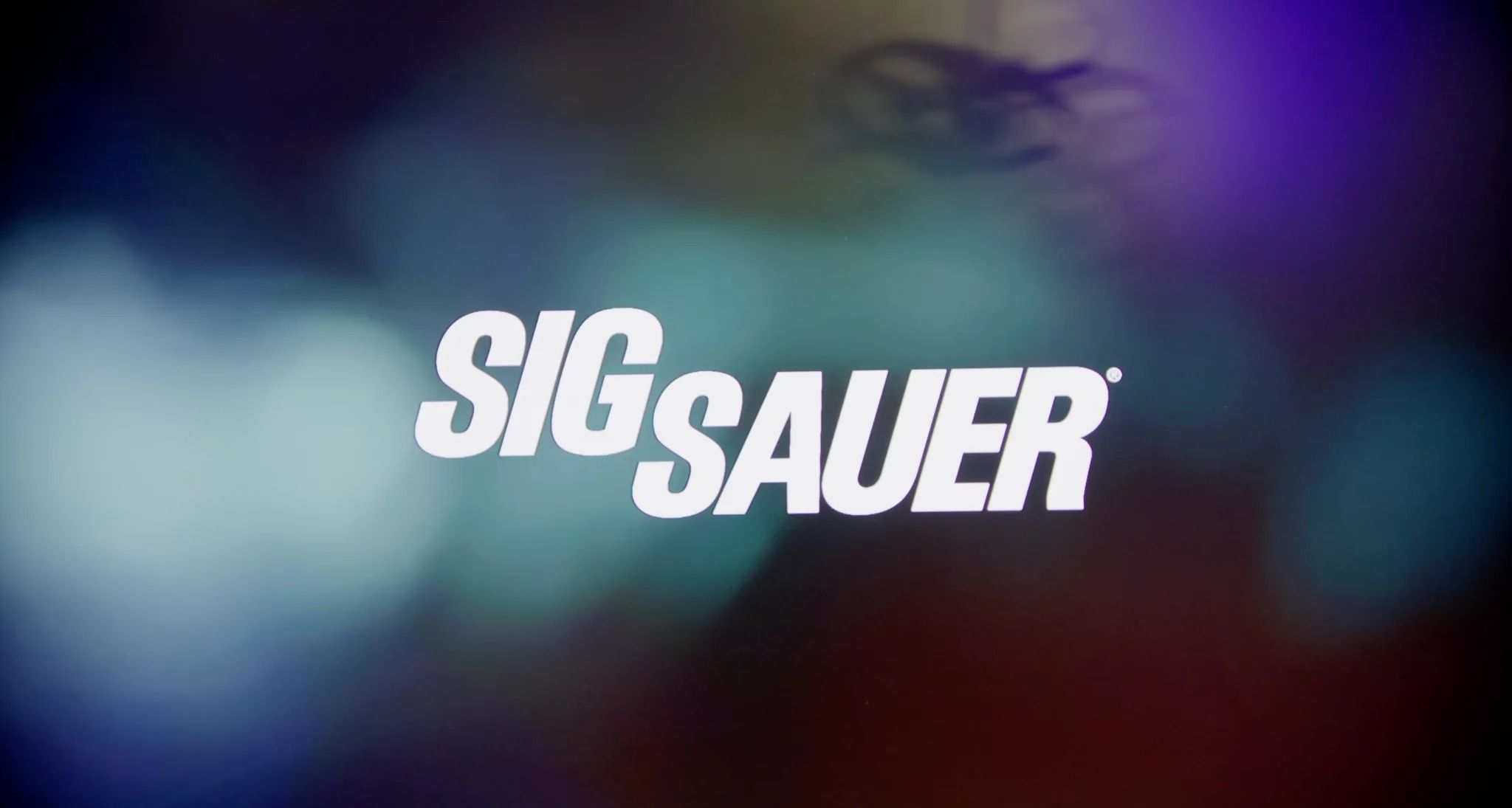 The Sig Sauer logo over blurred event lights, from the Sig Sauer and Modern Marine highlight reel