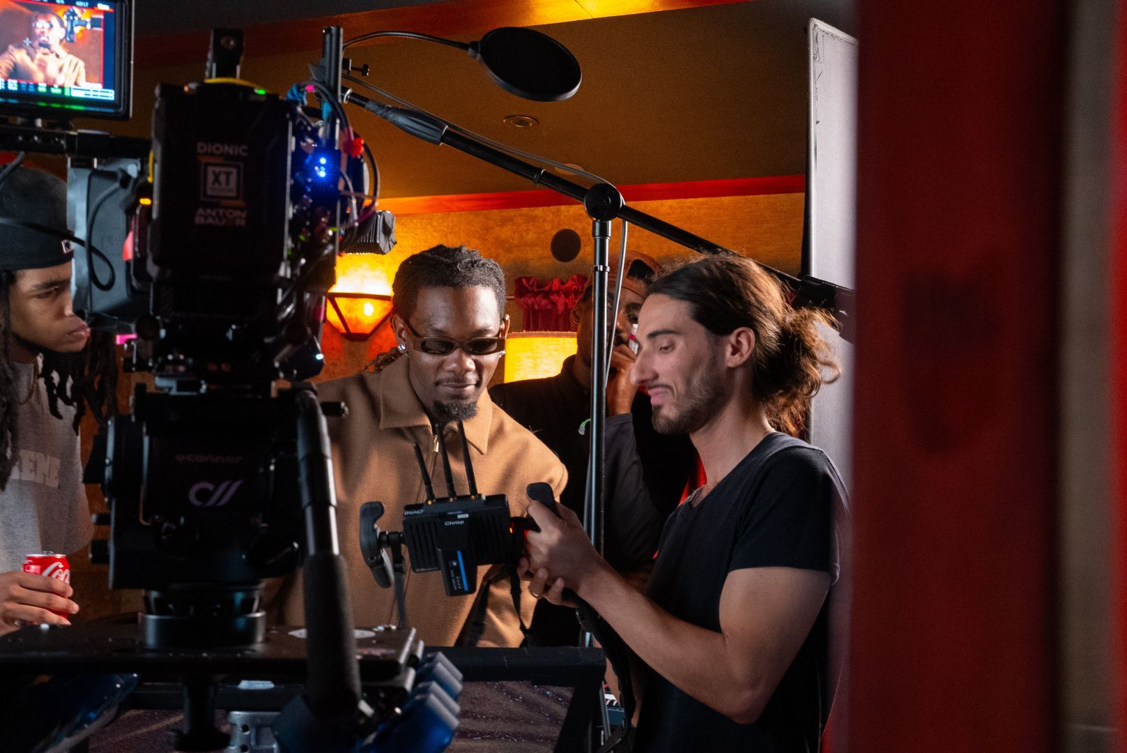 Maui shows Offset a take on a handheld monitor on the set of the Instagram livestream announcement.