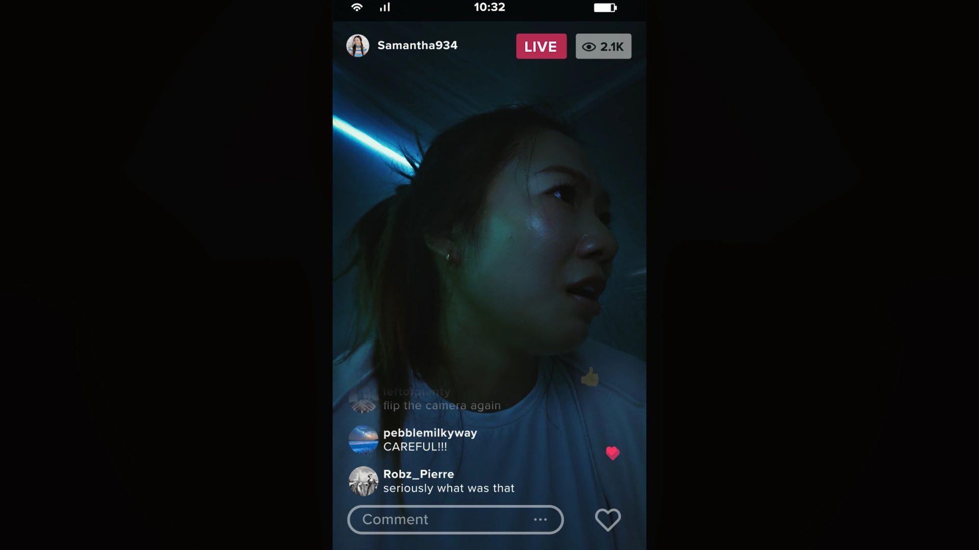 A phone screen shows a live stream from a dark corridor, with viewer comments along the bottom