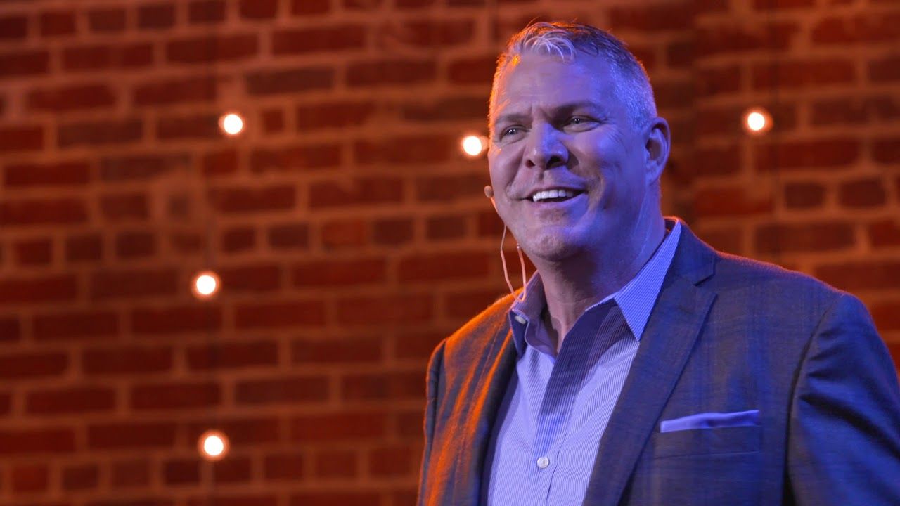 Rob Scheer smiling on the TEDxTysons stage