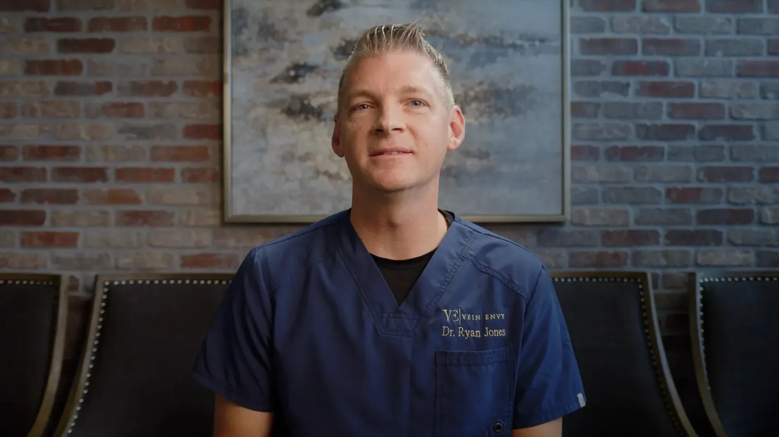 Dr. Ryan Jones of Vein Envy in navy scrubs, seated for an interview.
